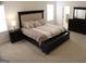 Spacious bedroom with a padded headboard bed, dark wood furniture and plenty of natural light from large windows at 878 W Union Grove Cir, Auburn, GA 30011
