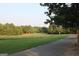 Picturesque park view with a winding path through green fields and trees, creating a tranquil environment at 878 W Union Grove Cir, Auburn, GA 30011