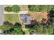 Aerial view of a home with a gray roof, surrounded by mature trees and a well-manicured lawn at 150 Cold Harbor Ct, Sharpsburg, GA 30277