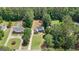 Drone view of the property showing the beautiful home nestled among mature trees in a quiet neighborhood at 150 Cold Harbor Ct, Sharpsburg, GA 30277