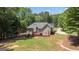 Aerial view of the home showcasing the landscaped backyard and mature trees at 150 Cold Harbor Ct, Sharpsburg, GA 30277
