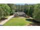 An aerial view of a well-maintained home with lush greenery and a long, private driveway at 150 Cold Harbor Ct, Sharpsburg, GA 30277