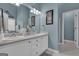 Bathroom with double vanity, white cabinets, framed mirrors, and blue walls, offering a serene atmosphere at 150 Cold Harbor Ct, Sharpsburg, GA 30277