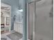 Well-lit bathroom with a shower, vanity, and blue walls, accessible from a bedroom at 150 Cold Harbor Ct, Sharpsburg, GA 30277