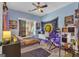Bright bedroom with colorful accents, featuring a bed, work space, and natural light at 150 Cold Harbor Ct, Sharpsburg, GA 30277