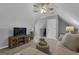 This bonus room features a tv, couch, and guitar at 150 Cold Harbor Ct, Sharpsburg, GA 30277