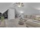 Cozy bonus room featuring a comfortable sofa and a ceiling fan at 150 Cold Harbor Ct, Sharpsburg, GA 30277
