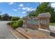 Stone community sign reading 'Bedford Forrest' with decorative plantings under a blue sky at 150 Cold Harbor Ct, Sharpsburg, GA 30277