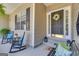 Inviting front porch with comfortable seating and a welcoming wreath on the front door at 150 Cold Harbor Ct, Sharpsburg, GA 30277