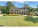 Charming home featuring a well-manicured lawn and inviting front porch at 150 Cold Harbor Ct, Sharpsburg, GA 30277