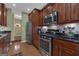 Updated kitchen showcases stainless steel appliances, granite countertops, and plentiful wood cabinetry at 150 Cold Harbor Ct, Sharpsburg, GA 30277