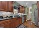 Kitchen featuring granite countertops, wooden cabinetry, stainless steel appliances, and hardwood flooring at 150 Cold Harbor Ct, Sharpsburg, GA 30277