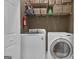 This laundry room features a washer, dryer, shelving and storage baskets at 150 Cold Harbor Ct, Sharpsburg, GA 30277