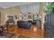 Warm living room featuring hardwood floors, high ceilings, and leather furniture at 150 Cold Harbor Ct, Sharpsburg, GA 30277