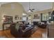 Spacious living room with a fireplace and hardwood floors, filled with natural light at 150 Cold Harbor Ct, Sharpsburg, GA 30277