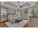 Spacious main bedroom features hardwood floors, tray ceiling, and neutral tones for a relaxing ambiance at 150 Cold Harbor Ct, Sharpsburg, GA 30277