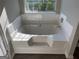 Close-up view of a pristine bathtub with tile surround and chrome fixtures at 5678 Mill View Way, Lithonia, GA 30038