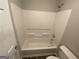 Bathroom with a sleek shower and tub combination, complemented by a toilet and neutral color scheme at 5678 Mill View Way, Lithonia, GA 30038
