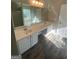 Bright bathroom with a long double sink vanity, large mirror, and tile flooring at 5678 Mill View Way, Lithonia, GA 30038