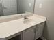 Bathroom vanity featuring a large mirror, a clean sink, and white cabinets for storage at 5678 Mill View Way, Lithonia, GA 30038