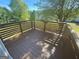 Wooden deck providing an inviting outdoor space to enjoy the surrounding greenery and sunlight at 5678 Mill View Way, Lithonia, GA 30038