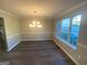 Dining room with modern dark floors, wainscoting and a large window at 5678 Mill View Way, Lithonia, GA 30038