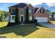 Charming brick two-story home with a well-manicured lawn and attached two-car garage at 5678 Mill View Way, Lithonia, GA 30038