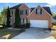 Charming brick two-story home with an attached two-car garage and manicured landscaping at 5678 Mill View Way, Lithonia, GA 30038