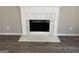 A white marble fireplace with a black insert and hardwood flooring at 5678 Mill View Way, Lithonia, GA 30038