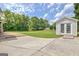 Expansive backyard featuring a large lawn, storage shed and concrete patio, ideal for outdoor activities at 503 Atwood Cir, Peachtree City, GA 30269