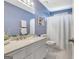 Blue bathroom featuring a vanity with a white marble top, a shower, and modern fixtures at 503 Atwood Cir, Peachtree City, GA 30269