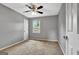 Bedroom featuring gray walls, a ceiling fan, natural light from a window, and carpeted flooring at 503 Atwood Cir, Peachtree City, GA 30269