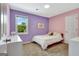 Cozy bedroom with purple and pink walls, a comfy bed, and a sunlit window at 503 Atwood Cir, Peachtree City, GA 30269