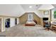 Spacious bedroom featuring a sloped ceiling, closets, and ample natural light from a window at 503 Atwood Cir, Peachtree City, GA 30269