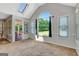 Bright bonus room with a skylight, large arched window, and a doorway to the screened-in porch at 503 Atwood Cir, Peachtree City, GA 30269