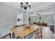 A spacious dining room offers classic chandelier and open floorplan at 503 Atwood Cir, Peachtree City, GA 30269