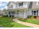 Inviting home with a charming front porch, decorative columns and neatly trimmed shrubbery at 503 Atwood Cir, Peachtree City, GA 30269