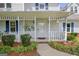 Charming home with a covered front porch, decorative columns, and lush landscaping at 503 Atwood Cir, Peachtree City, GA 30269