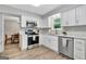 This modern kitchen has stainless steel appliances, white cabinets, and lots of natural light at 503 Atwood Cir, Peachtree City, GA 30269