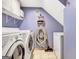 Practical laundry room features a washer, dryer, storage cabinets, and space for a freezer at 503 Atwood Cir, Peachtree City, GA 30269