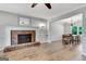 Bright living room features hardwood floors, red brick fireplace, and neutral paint at 503 Atwood Cir, Peachtree City, GA 30269