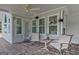 Cozy covered patio with comfortable seating, ceiling fan, and ample natural light at 503 Atwood Cir, Peachtree City, GA 30269