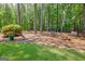 Secluded backyard seating area with a pair of chairs, and a fire pit near a wooded fence line at 111 Biltmore Trce, Peachtree City, GA 30269