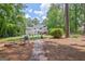 Large backyard featuring pool, lawn, patio, firepit, wooded area, and private setting at 111 Biltmore Trce, Peachtree City, GA 30269