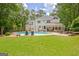 Beautiful backyard with a pool, lounge chairs, patio, covered patio, and a spacious grassy lawn at 111 Biltmore Trce, Peachtree City, GA 30269