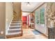 Open foyer featuring hardwood floors, staircase, and entryway to the dining room at 111 Biltmore Trce, Peachtree City, GA 30269