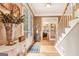 Bright foyer featuring hardwood floors, staircase, and entryway to a home office at 111 Biltmore Trce, Peachtree City, GA 30269