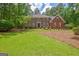 Charming brick home with a well-manicured lawn and mature trees in a desirable neighborhood at 111 Biltmore Trce, Peachtree City, GA 30269