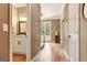 Hallway with hardwood floors leading to the foyer and a glimpse of the half bathroom at 111 Biltmore Trce, Peachtree City, GA 30269
