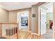 Hallway with hardwood floors, a wooden chest, and doorways leading to different rooms at 111 Biltmore Trce, Peachtree City, GA 30269